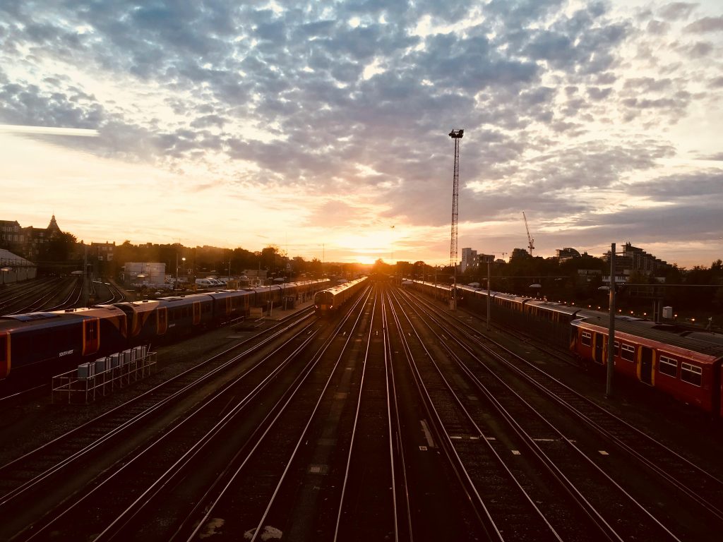 A stunning sunset view over railway tracks with trains lined up, capturing a moment of urban tranquility.